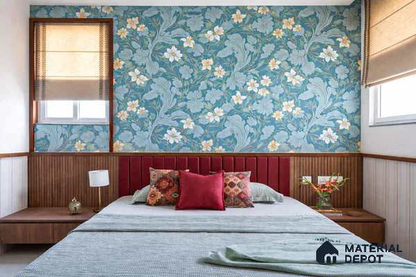 Eclectic bedroom with blue floral wallpaper, fluted wood paneling, and burgundy suede upholstered headboard