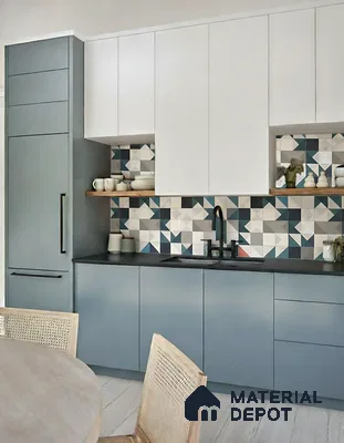 Modern kitchen with dual tone white and slate blue laminate, geometric patterned backsplash tiles, and matte black countertop of 3 BHK apartment in Prestige North Point Kalyan Nagar in Bengaluru