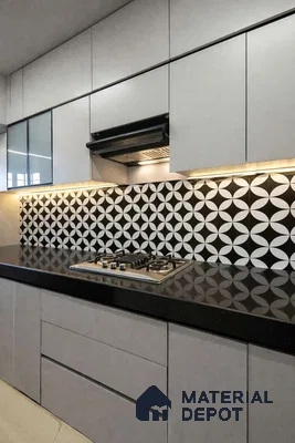 Modern kitchen with grey matte laminate cabinets, black quartz countertop, and black-and-white geometric backsplash tiles