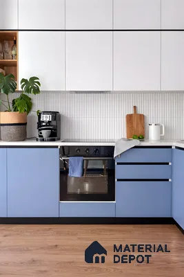 Modern kitchen with pastel blue and frosty white laminate, white quartz countertop, and fluted white backsplash tile