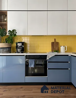 Modern kitchen with blue and white laminate cabinets, yellow subway tile backsplash, and wooden flooring of 3 BHK apartment in Pristine Meadows Jakkur Bengaluru