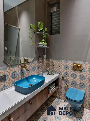 Modern bathroom with blue floral patterned tiles, matte grey wall tiles, and blue ceramic sanitaryware