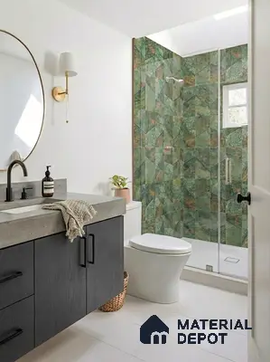 Modern bathroom with green geometric wall tiles, concrete countertop, and black wood vanity