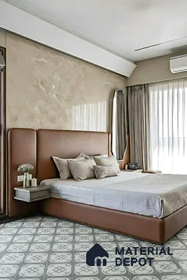 Modern bedroom with beige suede upholstered bed and grey floral patterned floor tiles of 3 BHK apartment in SLV Suhas Celestia Jalahalli Bengaluru