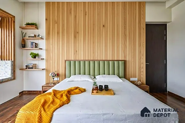 Scandinavian bedroom with vertical oak wood wall panels and green suede upholstered bed of 3 BHK apartment in SMR Vinay Endeavour Hoodi Bengaluru