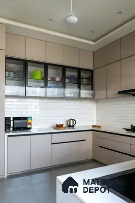 Modern kitchen with beige laminate cabinets, white quartz countertop, and white subway tile backsplash of 3 BHK apartment in SMR Vinay Endeavour Hoodi Bengaluru