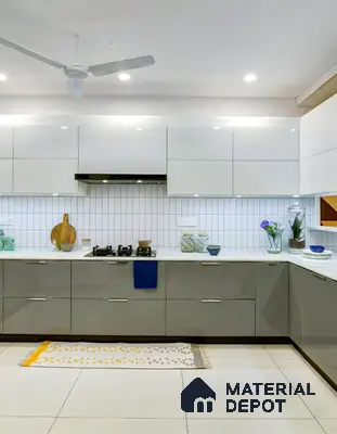 Modern dual tone kitchen with frosty white and grey high gloss laminate, white quartz countertop, and white subway backsplash tiles in 2 BHK apartment SSVR Lotus Pond Varthur Road Bengaluru
