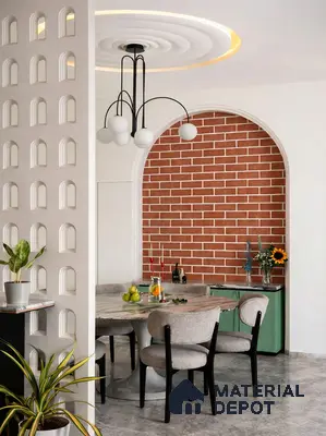 Modern dining room with brick look wall tile, marble dining table, and mint green laminate cabinetry