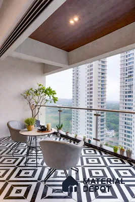 Modern balcony with geometric black-and-white floor tiles and glass railing