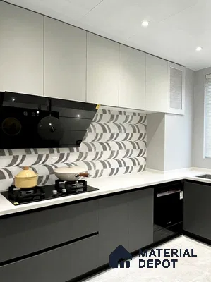 Modern kitchen with grey and white laminate cabinets, white quartz countertop, and geometric patterned backsplash tile