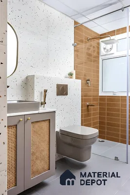 Modern bathroom with terrazzo wall tiles, terracotta subway shower tiles, and cane vanity of 3 BHK apartment in Sattva Celesta Salapuria in Bengaluru