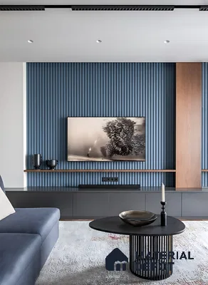 Modern living room with blue fluted wall panels, grey matte TV unit, and wooden accent of 3 BHK apartment in Sattva Celesta Salapuria in Bengaluru