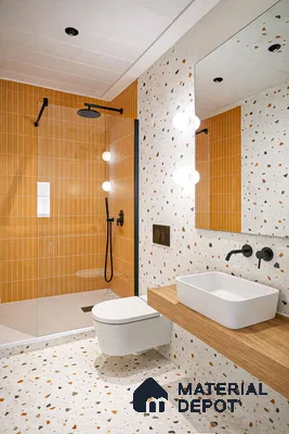 Modern bathroom with orange kitkat wall tiles and terrazzo floor and wall tiles