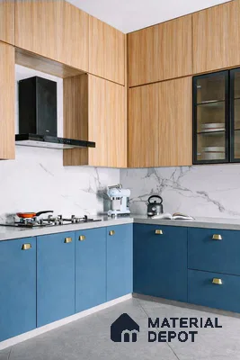 Modern kitchen with blue laminate base cabinets, light oak wood laminate overheads, and marble-look backsplash