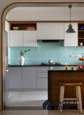 Modern kitchen with frosty white laminate, aqua blue scallop backsplash tile, and black quartz countertop of 4 BHK apartment in Sobha Windsor Whitefield in Bengaluru