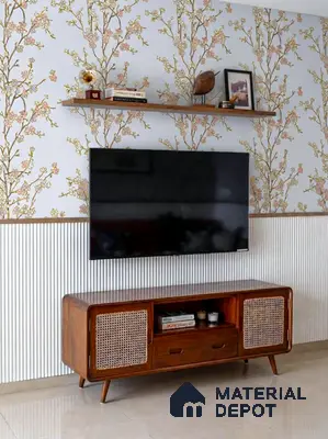 Mid-century modern TV unit with floral wallpaper, fluted wall panel, and cane-front wooden cabinet