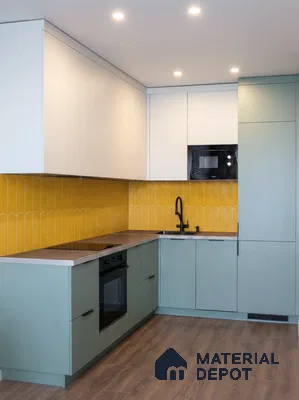 Modern kitchen with sage green and frosty white laminate, yellow patterned backsplash tile, and wood-look flooring