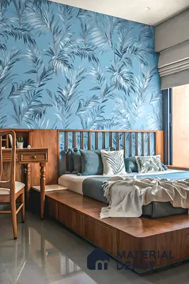 Modern bedroom with blue tropical wallpaper and walnut wood laminate platform bed of 3 BHK apartment in Shriram Sameeksha Jalahalli Bengaluru