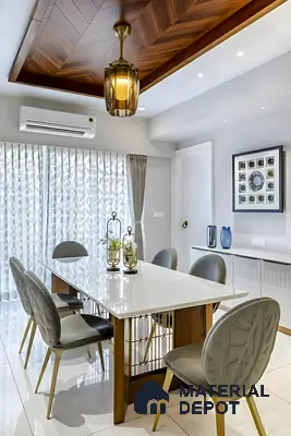 Modern dining room with white quartz tabletop, wooden base, and chevron wood ceiling panel of 3 BHK apartment in Shriram Sameeksha Jalahalli Bengaluru