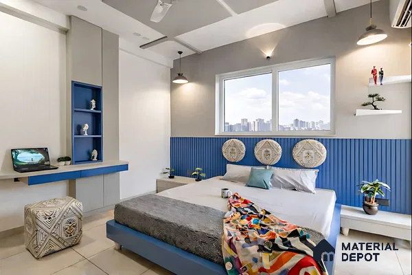 Modern bedroom with blue fluted wall panel, matte blue and grey laminate furniture, and beige floor tiles
