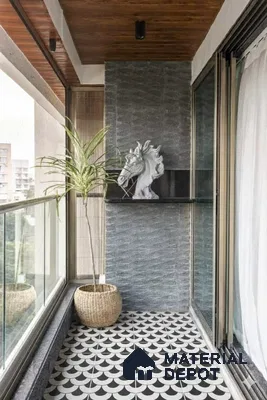 Modern balcony with geometric black-and-white patterned floor tiles and textured grey stone wall cladding