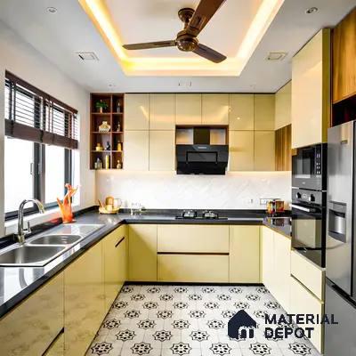 Modern kitchen with glossy beige laminate cabinets, black quartz countertop, and patterned black-and-white floor tiles in 3 BHK apartment Skav Aastha Mahalakshmi layout Bengaluru