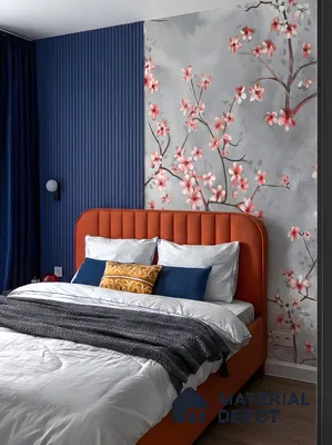 Japandi bedroom with floral chinoiserie wallpaper, blue fluted wall panels, and rust suede upholstered bed