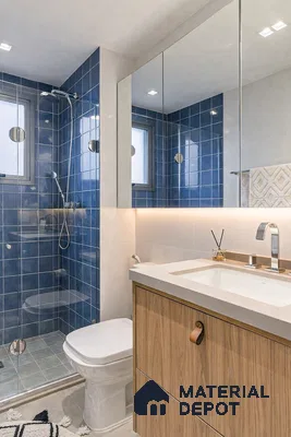 Modern bathroom with blue subway wall tiles, white countertop, and wood laminate vanity