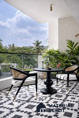 Modern balcony with black-and-white geometric patterned floor tiles and cane accent chairs