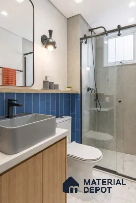 Modern bathroom with blue vertical subway wall tiles, light wood vanity, and grey stone floor tiles