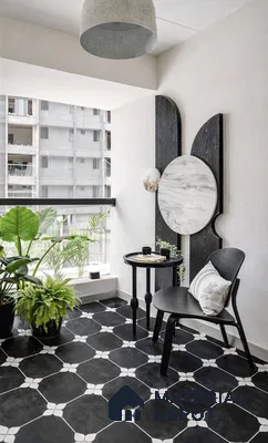 Minimalist balcony with black and white geometric floor tiles and modern decor in 2 BHK apartment Sree Adithya Lotus KR Puram Bengaluru