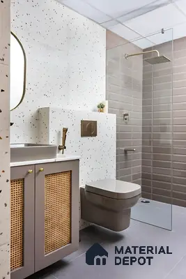 Modern bathroom with terrazzo wall tiles, taupe subway shower tiles, and cane-front vanity in 2 BHK apartment Sree Adithya Lotus KR Puram Bengaluru