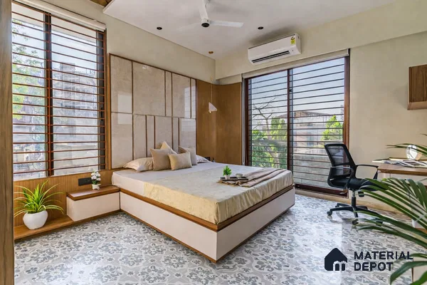 Modern bedroom with beige upholstered headboard, wood accents, and patterned grey and white floor tiles
