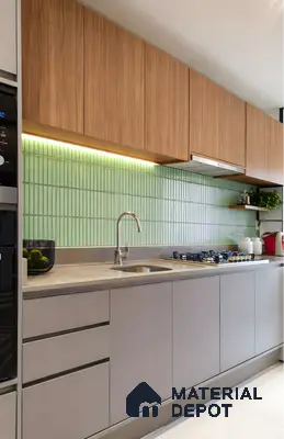 Modern kitchen with wood grain laminate, sage green kitkat backsplash tile, and taupe matte base cabinets in 3 BHK apartment Sterling Brookside Brookefield Bengaluru
