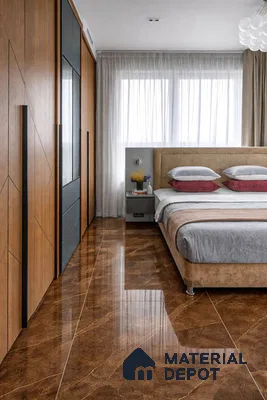 Modern bedroom with walnut wood laminate wardrobe and polished brown marble floor tiles