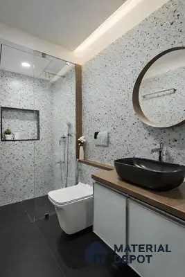 Modern bathroom with terrazzo wall tiles, matte black floor tiles, and brown countertop vanity