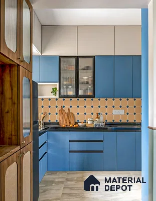 Modern kitchen with blue laminate cabinets, beige geometric backsplash tile, and black countertop in 3 BHK apartment Supertech Micasa Bellahalli Bengaluru