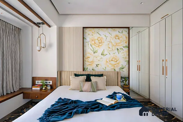 Modern bedroom with floral wallpaper accent, beige fluted wall panels, and frosty white wardrobe laminate