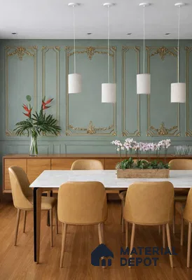 Art Deco dining room with sage green decorative wall panel, white marble tabletop, and tan leather chairs