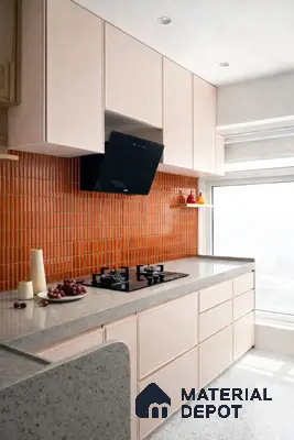 Modern kitchen with pastel pink laminate, orange kitkat backsplash tile, and terrazzo countertop