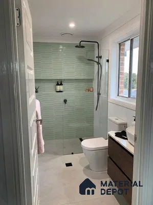 Modern bathroom with sage green elongated hexagonal wall tiles and wood vanity