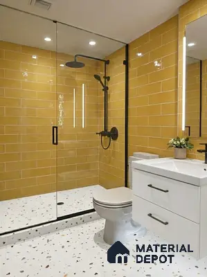 Modern bathroom with mustard yellow subway wall tiles and terrazzo floor tiles in 3 BHK apartment Vaishnavi Rathnam Jalahalli Bengaluru