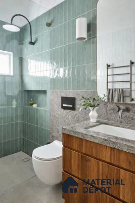 Modern bathroom with sage green vertical subway wall tiles, grey stone countertop, and walnut wood vanity