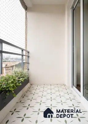 Minimalist balcony with green geometric patterned floor tiles and neutral walls