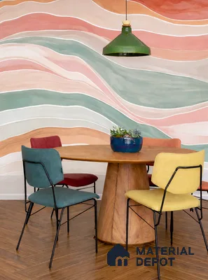 Eclectic dining room with abstract pastel wallpaper, wooden dining table, and herringbone wood flooring