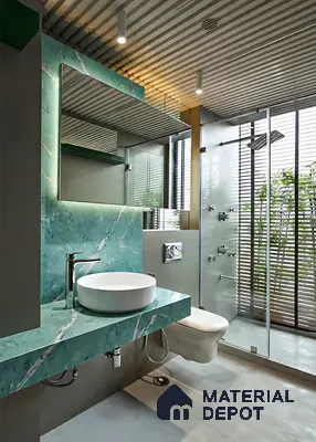 Modern bathroom with green marble vanity, wall cladding, and glass shower partition