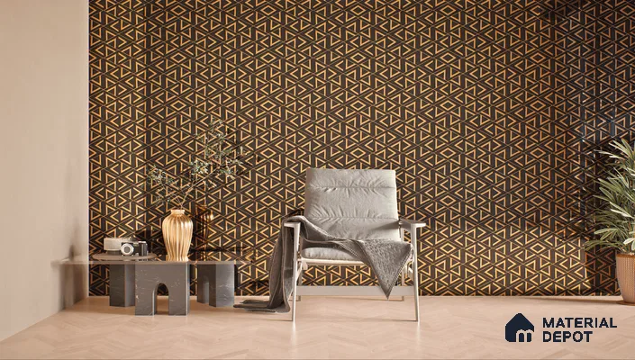 A living room with a geometric wallpaper accent wall and a chair in front of it. The geometric design incorporates glass highlighter tiles that create a shimmering effect.