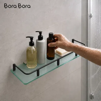 Bathroom Glass Shelf - frosted glass shelf with black rail holding toiletries on a grey shower wall