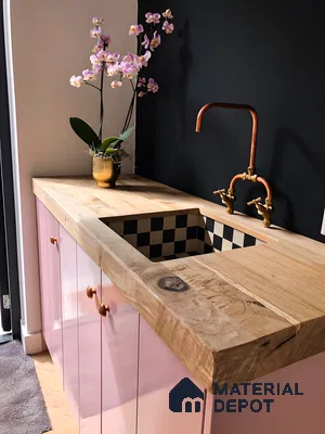 Blush Charm: Soft Pink Cabinetry Paired with Natural Wood Countertop and Retro Black Checkered Sink Detail | Material Depot