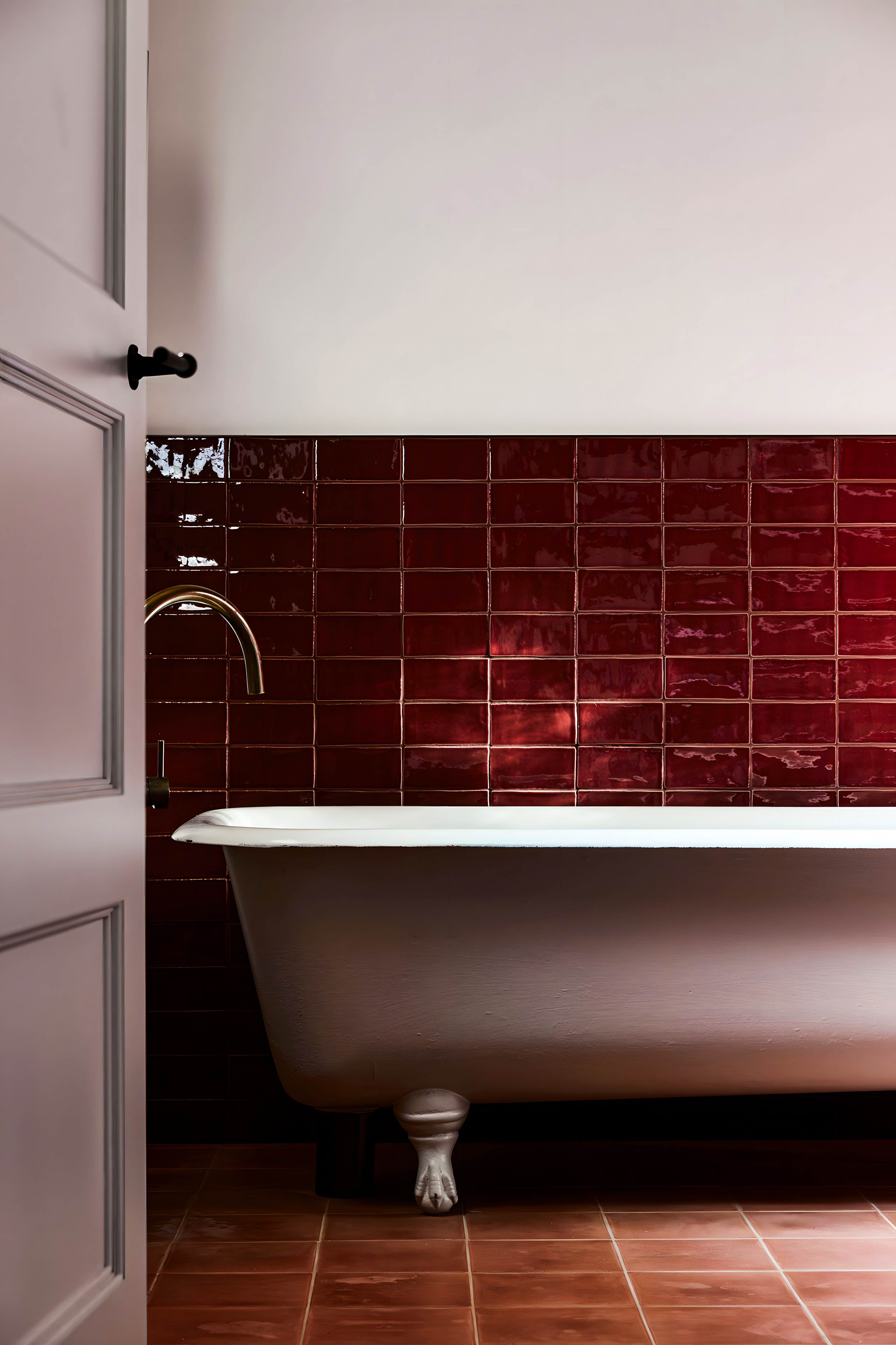 Chic Bathroom with Classic Bathtub and Burgundy Tiles | Material Depot